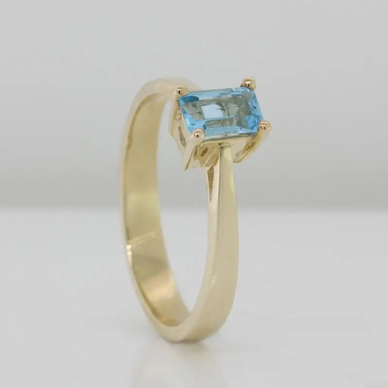 9 Carat Yellow Gold 6mm x 4mm Emerald Cut Blue Topaz Solitaire Ring Size P